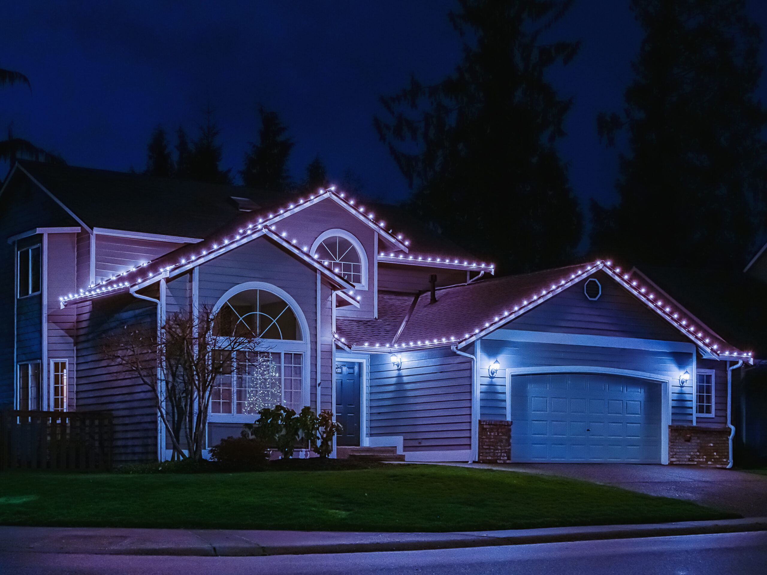 American suburban home exterior with festive Christmas lights