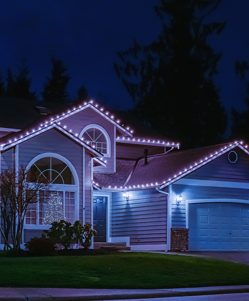 American suburban home exterior with festive Christmas lights